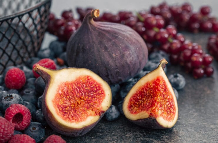 Close-up, figs in the cut among the berries.